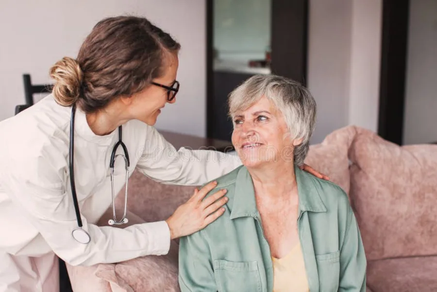 Nurse with happy senior woman